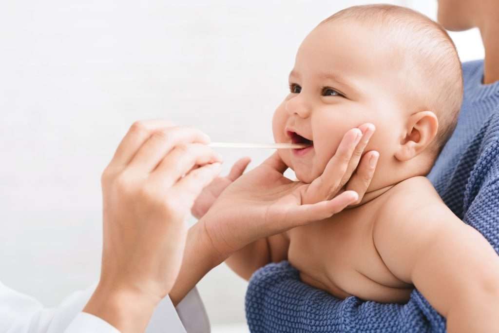 Pediatric healthcare provider examining an infant during a wellness visit to support children's health and development.