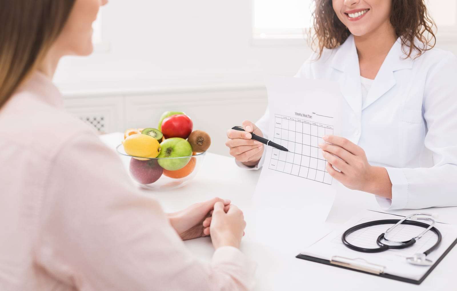 Healthcare provider reviewing a personalized nutrition plan with a patient to address nutritional deficiencies and improve overall health.
